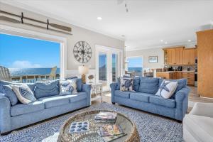 a living room with two blue couches and a table at Shore Bet in Surf City