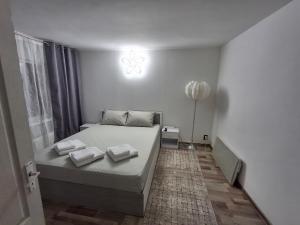 a bedroom with a bed with two pillows on it at Casa Stadion in Craiova