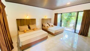Ένα ή περισσότερα κρεβάτια σε δωμάτιο στο Seravelle Kitulgala