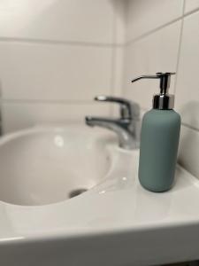 a bathroom sink with a soap dispenser on it at Kotkanpesä in Ylläs +27 photos