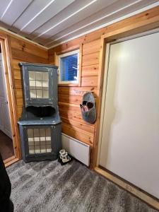 a tiny house with a stove in a room at Kotkanpesä in Ylläs