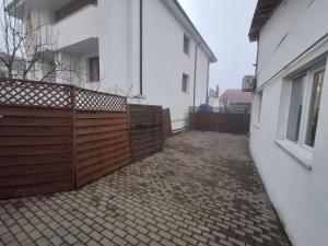 a wooden fence in front of a white building at Casa Stadion in Craiova