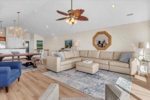 a living room with a couch and a table at Drift Away in Topsail Beach
