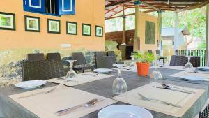 a table with white plates and wine glasses on it at Seravelle Kitulgala in Kitulgala