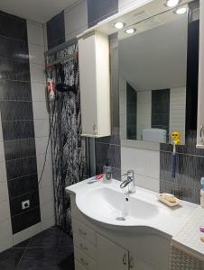 a bathroom with a sink and a mirror at Ambient Light apartment Sarajevo with free parking in Sarajevo +17 photos