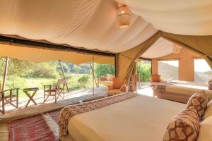 Postel nebo postele na pokoji v ubytování Entumoto Safari Camp - Masai Mara