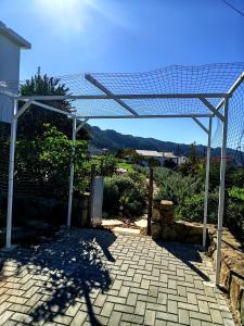 a pergola over a brick walkway at Casa 99 in Miranda do Corvo +3 photos