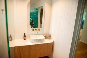 a bathroom with a sink and a mirror at El Parche Bilinga Beachside, Unit 5, Sleeps 6 in Gold Coast