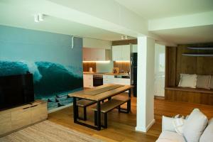 a living room with a table and a kitchen at El Parche Bilinga Beachside, Unit 5, Sleeps 6 in Gold Coast +24 photos
