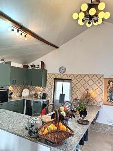 a kitchen with a counter with a basket of fruit at Casa 99 in Miranda do Corvo