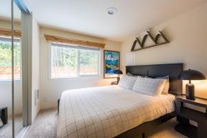 um quarto com uma cama grande e duas janelas em NEW Nestled Private Tiny Home Situated Near ONP em Port Angeles