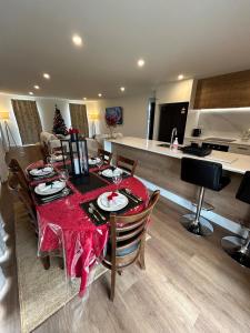 a dining room with a table with a red table cloth at Stackwood Lodge - Relaxed stay for all seasons in Woodend