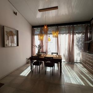 a dining room with a table and chairs and a window at loft de diseño in Paysandú +18 photos