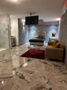 a living room with a bed and a couch at Le Palais Du Khalif in Fabrègues