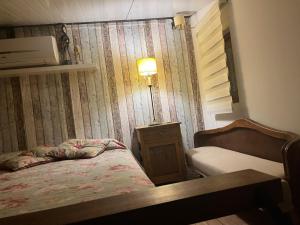 a bedroom with a bed and a table and a lamp at loft de diseño in Paysandú