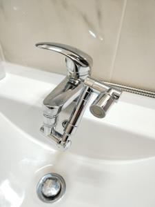 een wastafel in de badkamer met een chromen kraan bij Casa 99 in Barbéns, Miranda do Corvo in Miranda do Corvo