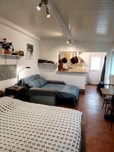 a bedroom with two beds and a table and chairs at Casa 99 in Miranda do Corvo