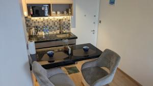 a kitchen with a table and two chairs at Mimi homes in Tatu City +4 photos