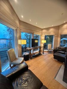 a living room with a couch and a television at Best Cottage in Ruokolahti
