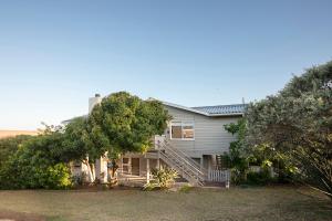 a house with a staircase in front of it at Leef op Hoop in Boggomsbaai
