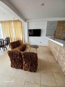 een woonkamer met een bank en een tafel bij Beach House in Punta Negra