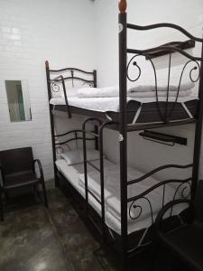 two iron bunk beds in a room with a mirror at The Hostel in Kyiv
