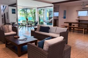 a living room with a couch and chairs and a table at Casa Cielo in La Libertad