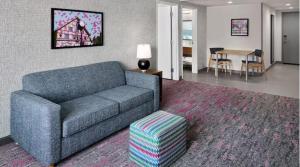 a living room with a couch and a table at Home 2 Suites by Hilton Frankenmuth in Frankenmuth