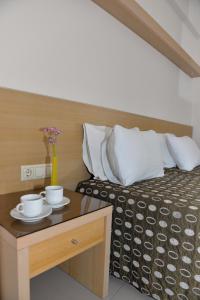 Postel nebo postele na pokoji v ubytování Kyridis Hotel