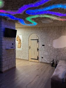 Leśna Grota na Roztoczu في Górecko Stare: غرفة بها باب وجدار حجري