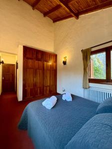 a bedroom with a blue bed with two towels on it at Nevada Hostel in San Carlos de Bariloche