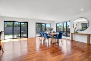 a dining room with a table and chairs and a mirror at Goonawarra Getaway at Mooloolaba in Mooloolaba