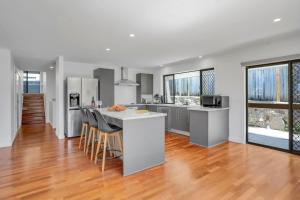 a kitchen and living room with a counter top at Goonawarra Getaway at Mooloolaba in Mooloolaba