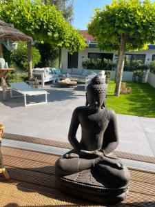 a statue of a meditating woman sitting on the ground at B&B Bubbles&Bites in Oostvoorne