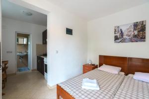 a hotel room with a bed and a bathroom at Apartments Lora in Bar