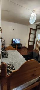 a bedroom with a bed and a tv in a room at Le spacieux in Cherbourg en Cotentin +2 photos