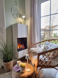 uma sala de estar com lareira e uma cama em Düne 4 - Ferienunterkunft mit eigenem Garten in der beliebten Dünenresidenz - sanftes Meeresrauschen inklusive em Ostseebad Karlshagen