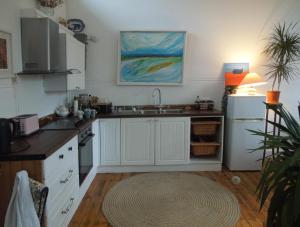 a kitchen with white cabinets and a sink at Durrus in Durrus