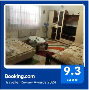 a picture of a room with two beds and a tv at Niš Apartman in Niš