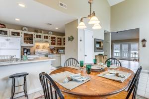 a kitchen and dining room with a wooden table and chairs at Fire Pit and Boat Dock Lake Chatuge Townhome! in Hiawassee