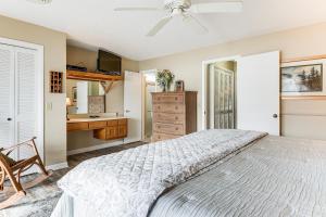 a bedroom with a bed and a desk and a dresser at Fire Pit and Boat Dock Lake Chatuge Townhome! in Hiawassee