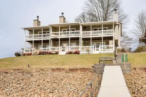 a large house sitting on top of a hill at Fire Pit and Boat Dock Lake Chatuge Townhome! in Hiawassee