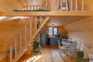 a wooden house with a christmas tree in a room at Kamara in Sioni