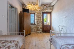 a room with two beds and a window and a door at Villa Natalia in Grižane