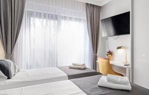 een hotelkamer met twee bedden en een raam bij Quercus Vodice in Vodice