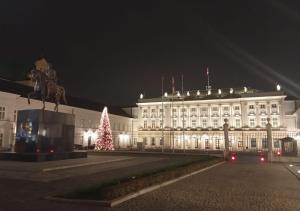 a large white building with a christmas tree in front of it at Tylko dla Orłów in Warsaw