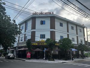 a large building with a sign on top of it at Hotel Cốc Cốc 2 in Ấp Rạch Mẹo