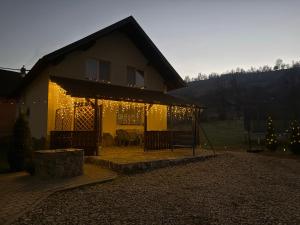 een verlicht huis met kerstverlichting erop bij Casa In Curte La Zavate in Bran