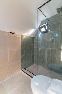 a bathroom with a glass shower with a toilet at Kamara in Sioni