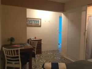 a living room with a table and chairs and a room at Mini Vacation in Chelem in Chelem
